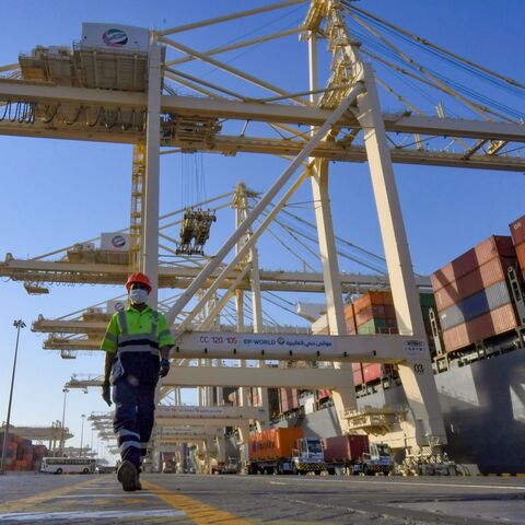 An employee wearing a face mask against the coronavirus, is pictured at the port of Jebel Ali, operated by the Dubai-based giant ports operator DP World, in the southern outskirts of the Gulf emirate of Dubai, on June 18, 2020. 