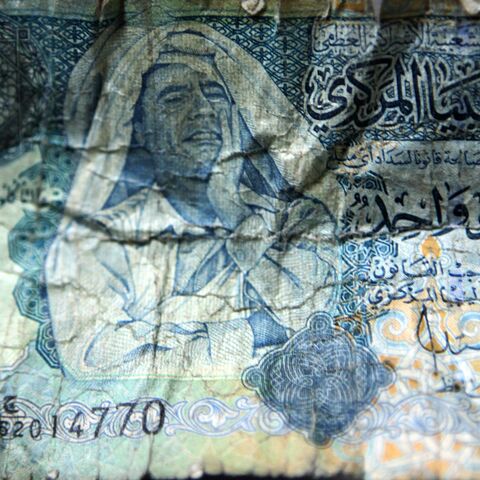 Picture of a Libyan dinar banknote bearing a portrait of former leader Moammar Gadhafi is pictured in Tripoli, on Sept. 8, 2011.