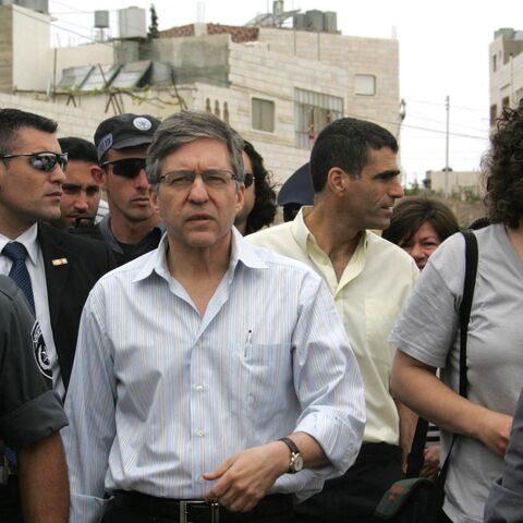 Israeli police escort Israeli former Justice Minister Yossi Beilin.