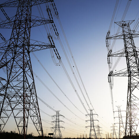 The sun sets behind overhead power lines as the Kuwaiti Ministry of Electricity requested citizens to ration their electricity usage at peak times due to outages caused by the increased pressure on power stations amid soaring temperatures and heightened energy demand, Kuwait City, Kuwait, June 19, 2024.