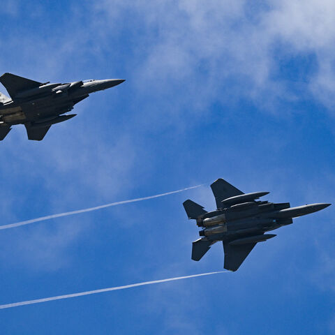 Two F-15 Strike Eagle's take part in an air display on the opening day of the Farnborough International Airshow 2024, south west of London, on July 22, 2024. 