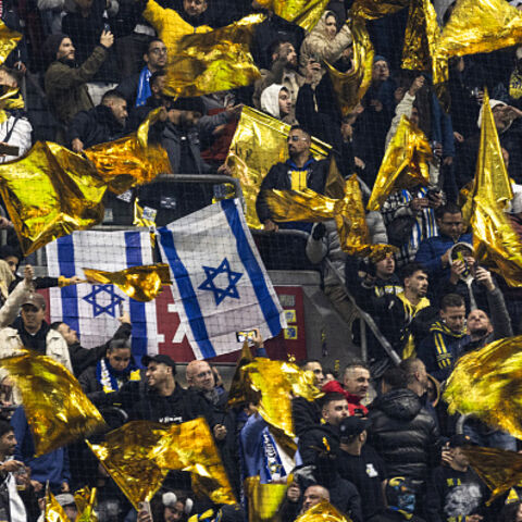 OPSHOT - Maccabi supporters wave yellow flags next to Israeli flags during the UEFA Europa League, League phase - Matchday 4, football match between Ajax Amsterdam and Maccabi Tel Aviv at the Johan-Cruijff stadium, in Amsterdam on November 7, 2024. (Photo by Robin van Lonkhuijsen / ANP / AFP) / Netherlands OUT (Photo by ROBIN VAN LONKHUIJSEN/ANP/AFP via Getty Images)