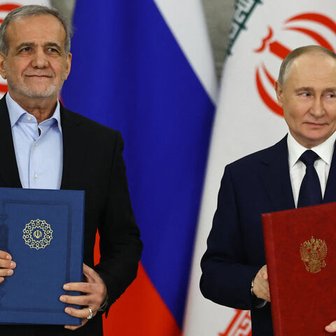 Russian President Vladimir Putin and Iranian President Masoud Pezeshkian sign a strategic partnership treaty during a ceremony following their talks at the Kremlin in Moscow on January 17, 2025. 