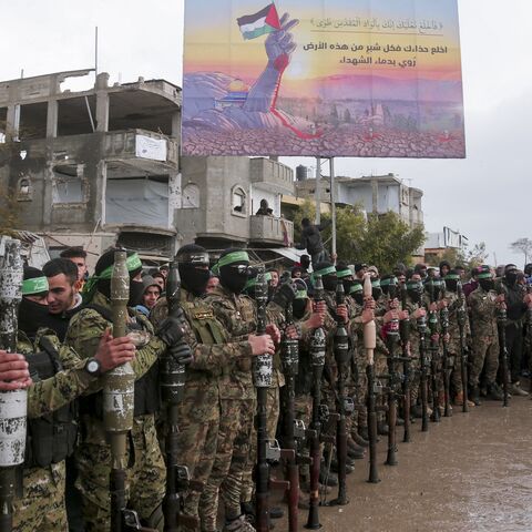 Hamas fighters gather at the site of the handing over of two Israeli hostages in Rafah in the southern Gaza Strip on Feb. 22, 2025. 