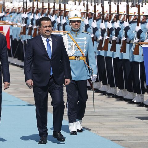 Turkish President Recep Tayyip Erdogan (L) and Iraqi Prime Minister Mohammed Shia al-Sudani review honor guards during the latter's official visit to Ankara, May 8, 2025.