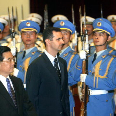 BEIJING, CHINA: Visiting Syrian President Bashar al-Assad (R) walks with Chinese President Hu Jintao (R), 22 June 2004, during a welcoming ceremony at the Great Hall of the People in Beijing. The visit is the first by a Syrian head of state to China since the two countries established relations in 1956. AFP PHOTO/POOL/Frederic J. BROWN (Photo credit should read FREDERIC J. BROWN/AFP via Getty Images)