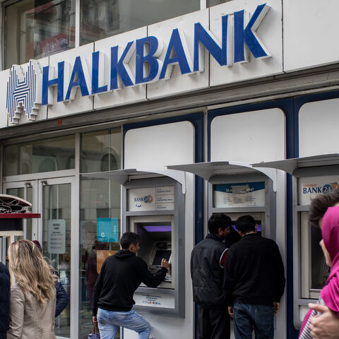 People walk past a branch of Turkish bank HalkBank on Dec. 1, 2017 in Istanbul, Turkey.