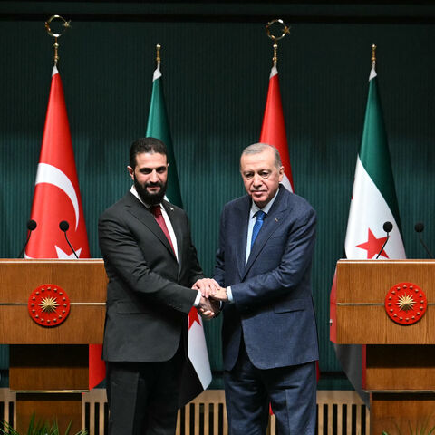 Turkish President Recep Tayyip Erdogan (R) and Syria's interim president Ahmed al-Sharaa shake hands during a joint press conference following their meeting at the Presidential Palace in Ankara, on Feb. 4, 2025. 