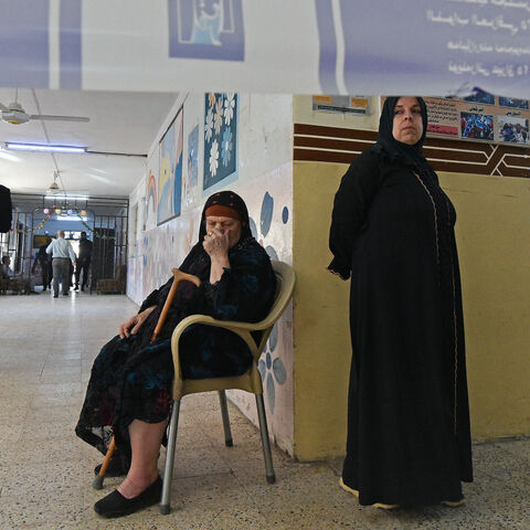 Iraqi voters wait to cast their ballots at the Al-Ghufran school, turned into a polling station in the northern Iraqi city of Mosul on Nov. 11, 2025 during Iraq's parliamentary elections. 