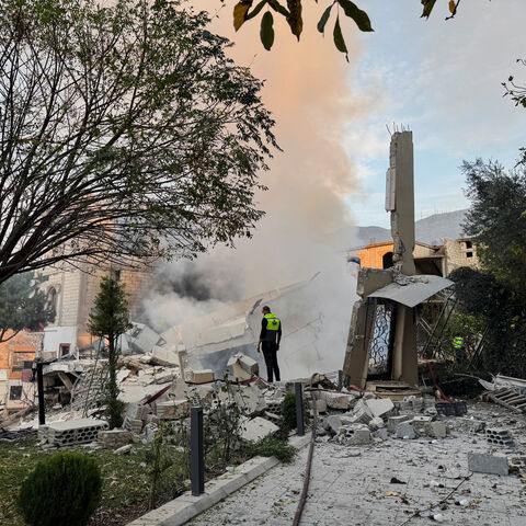 A civil defence member stands on rubble at a damaged site after Israel's military said it struck targets in two southern Lebanese towns on Thursday, in Jbaa southern Lebanon, December 4, 2025. REUTERS/Ali Hankir