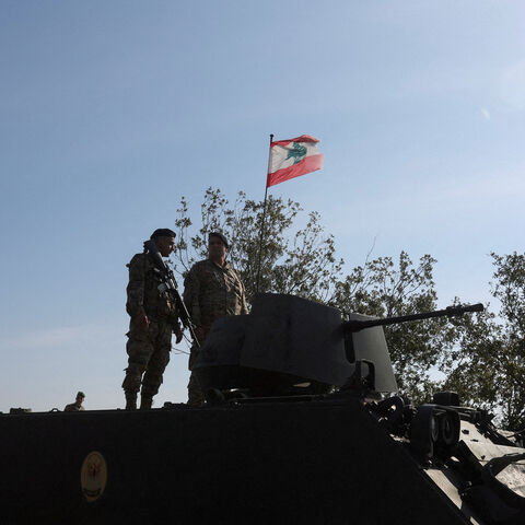 FILE PHOTO: Lebanese army members stand on a military vehicle during a Lebanese army media tour, to review the army's operations in the southern Litani sector, in Alma Al-Shaab, near the border with Israel, southern Lebanon, November 28, 2025. REUTERS/Aziz Taher/File Photo