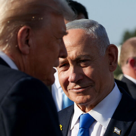 Israeli Prime Minister Benjamin Netanyahu looks on next to U.S. President Donald Trump as Trump leaves Israel en route to Sharm El-Sheikh, Egypt, to attend a world leaders' summit on ending the Gaza war, amid a U.S.-brokered prisoner-hostage swap and ceasefire deal between Israel and Hamas, at Ben Gurion International Airport in Lod, Israel, October 13, 2025. REUTERS/Evelyn Hockstein