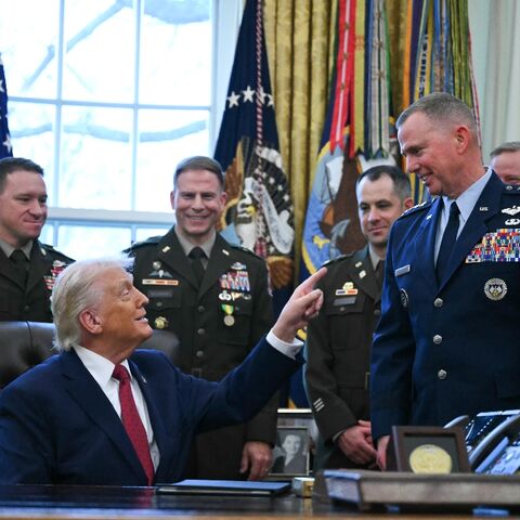 US President Donald Trump speaks with military officers at the White House