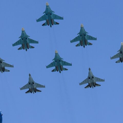 Russian Sukhoi Su-35S fighter aircrafts, Su-34 military fighter jets and Su-30SM jet fighters fly over downtown Moscow during a military parade on June 24, 2020. 