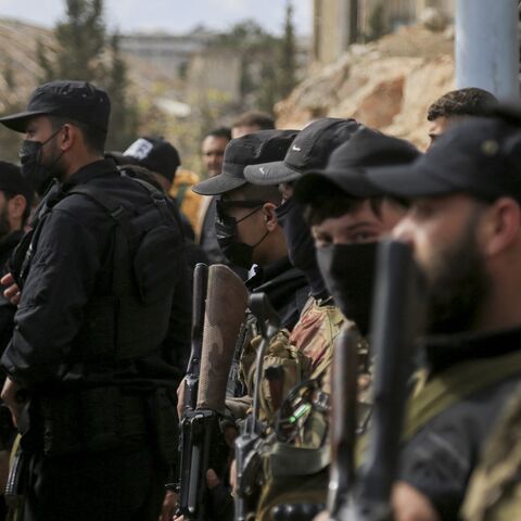 Armed personnel of SDF and public security forces of the new Syrian government stand guard in al-Ramun district of Aleppo, Syria, on April 3, 2025. 