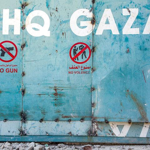 A boy sits outside the entrance to the United Nations Relief and Works Agency for Palestine Refugees (UNRWA) building complex in Gaza City, on Sept. 6, 2025.