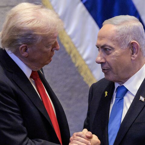 US President Donald Trump speaks with Israeli Prime Minister Benjamin Netanyahu at the Israeli parliament, the Knesset, in Jerusalem on Oct. 13, 2025.