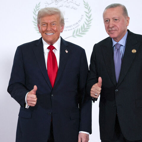 US President Donald Trump and Turkish President Tayyip Erdogan gesture as they pose for a photo during a world leaders' summit on ending the Gaza war on Oct. 13, 2025 in Sharm El-Sheikh, Egypt. 