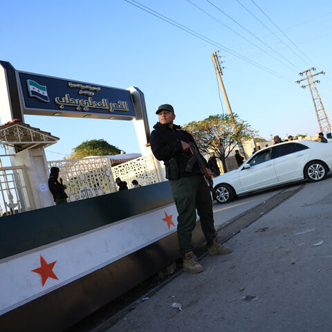 Security personnel from the Syrian Ministry of Interior stand outside the Justice Palace ahead of the first trial of more than a dozen suspects linked to massacres that left hundreds dead in Syria's Alawite coastal heartland earlier this year, in Aleppo on November 18, 2025. The first trial of more than a dozen suspects linked to massacres that left hundreds dead in Syria's Alawite coastal heartland earlier this year began on November 18, an AFP journalist in the courtroom said. The massacres in March, whic