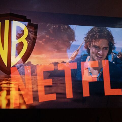 Multiple exposure photograph of the Netflix and Warner Bros logos in front of a television screen at Kerlouan in Brittany in France, on Dec. 5 2025.