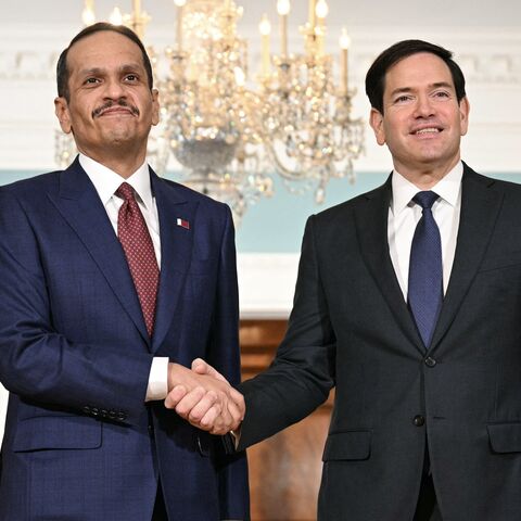US Secretary of State Marco Rubio (R) shakes hands with Qatari Prime Minister and Foreign Minister Mohammed bin Abdulrahman al-Thani at the State Department in Washington, on Dec. 17, 2025. 