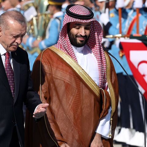 Turkish President Recep Tayyip Erdogan (L) gestures as he welcomes Crown Prince of Saudi Arabia Mohammed bin Salman (R) during an official ceremony at the Presidential Complex in Ankara, on June 22, 2022.