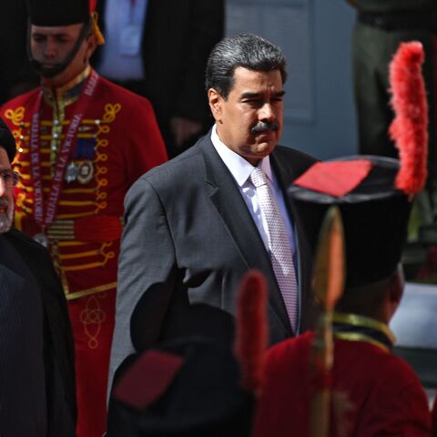 Iranian President Ebrahim Raisi (L) is welcomed by Venezuelan President Nicolas Maduro at Miraflores Presidential Palace in Caracas, on June 12, 2023. Iranian President Ebrahim Raisi arrived in Venezuela Monday for the start of a visit to "friendly countries" that also include Cuba and Nicaragua, all under sanctions from a common adversary, the United States. (Photo by Yuri CORTEZ / AFP) (Photo by YURI CORTEZ/AFP via Getty Images)