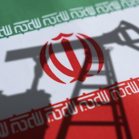 Oil rigs on the background of the Iranian flag. 