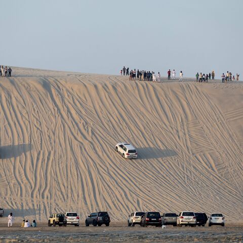 People spend time in the sealine desert south of Doha, Qatar, on November 1, 2024. (KARIM JAAFAR/AFP via Getty Images)