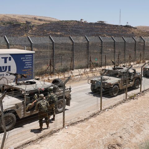 Israel military vehicles drive along the border fence into Israel, near the town of Majdal Shams, in the Israeli-annexed Golan Heights, on July 17, 2025. Syrian government forces have withdrawn from the whole of Sweida province after days of sectarian bloodshed in the heartland of the Druze minority, a war monitor and witnesses said July 17, 2025. (Photo by Jalaa MAREY / AFP) (Photo by JALAA MAREY/AFP via Getty Images)