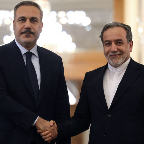Iran's Foreign Minister Abbas Araghchi (R) shakes hands with Turkey's Foreign Minister Hakan Fidan during press conference in Tehran on Nov. 30, 2025. 