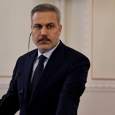 Turkey's Foreign Minister Hakan Fidan listens to Iran's foreign minister during a joint press conference, in Tehran on Nov. 30, 2025. 