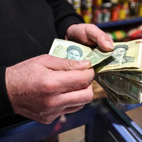 A shop owner counts Iranian banknotes at a store in the capital Tehran on Jan. 7, 2026. 