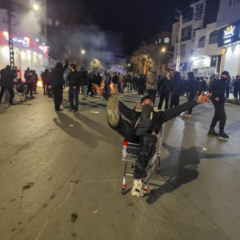 Iranians gather while blocking a street during a protest in Kermanshah, Iran on January 8, 2026. The nationwide protests started in Tehran's Grand Bazaar against the failing economic policies in late December, which spread to universities and other cities, and included economic slogans, to political and anti-government ones. (Photo by Kamran / Middle East Images / AFP via Getty Images)