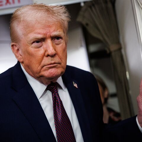 US President Donald Trump takes questions from the members of the press aboard Air Force One on Jan. 11, 2026, en route back to the White House from Palm Beach, Florida. 