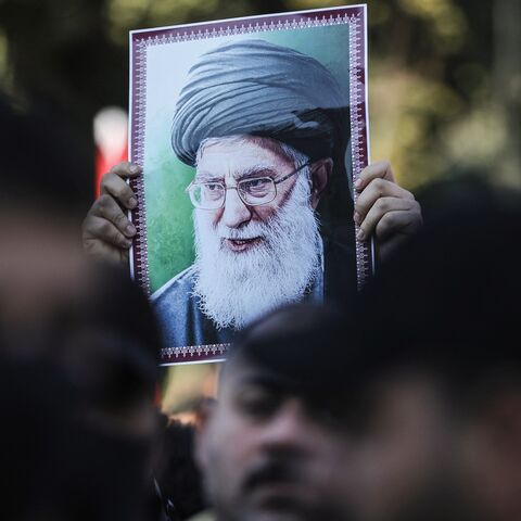 A protester holds up a portrait of Iran's Supreme Leader Ayatollah Ali Khamenei during a demonstration near the Iranian Embassy in Baghdad, on Jan. 16, 2026.