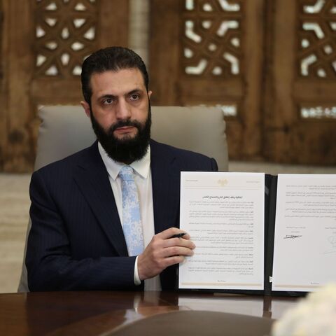 DAMASCUS, SYRIA - JANUARY 18: Syrian President Ahmed Al-Sharaa signs a ceasefire agreement with the Kurdish-led Syrian Democratic Forces (SDF) on January 18, 2026 in Damascus, Syria. According to Syrian state media, the deal includes a handover of Deir ez-Zor and Raqqa governates into government control, and the full integration of SDF fighters into state institutions. It follows the government's recent push towards the key city of Raqqa, after SDF fighters withdrew from Aleppo amid deadly clashes over the 