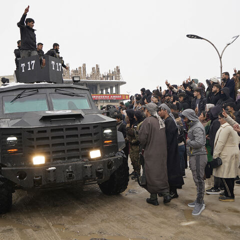 Members of Kurdish-led Syrian Democratic Forces (SDF) arrive at the Kurdish-held city of Ain al-Arab, also known as Kobane on January 23, 2026, after they withdrew from the Al-Aqtan prison in the Raqqa province of Syria. 