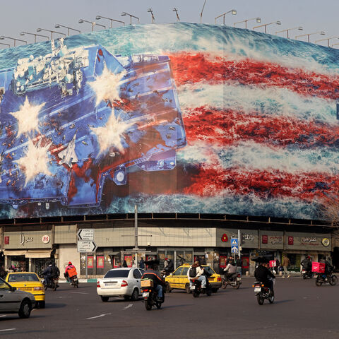 TOPSHOT - Cars drive past an anti-US billboard installed on a building at the Enqelab Square in Tehran on January 26, 2026. (Photo by ATTA KENARE / AFP via Getty Images)