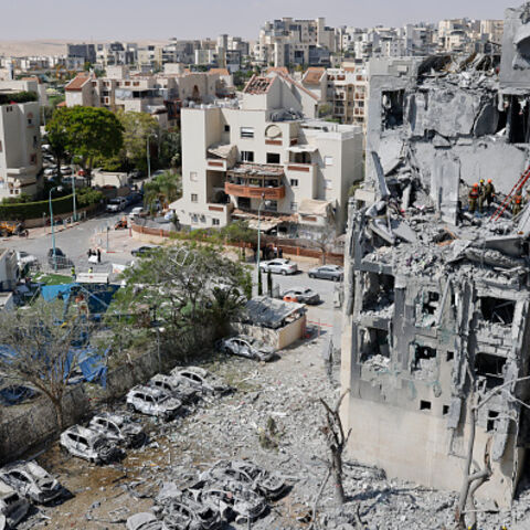 Emergency workers check the damage caused to a building from an Iranian missile strike in Beersheba in southern Israel on June 24, 2025. Israel said on June 24 it had agreed to US President Donald Trump's proposal for a ceasefire with Iran, on the 12th day of war between the foes. (Photo by John Wessels / AFP) (Photo by JOHN WESSELS/AFP via Getty Images)
