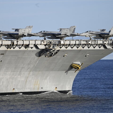 DENMARK-NORWAY-US-FRANCE-NATO-ARMY-DEFENCE-EXERCISE Picture taken on September 24, 2025 from the French Navy frigate Bretagne shows F-18 fighter jets on the deck of the the world's largest aircraft carrier USS Gerald R Ford as both ships are taking part in the NATO Neptune Strike 2025 exercise in the North Sea. According to NATO, more than 10,000 sailors, soldiers, aviators and marines from 13 allied nations took part in the large-scale multinational enhanced Vigilance Activity, running from September 22 to