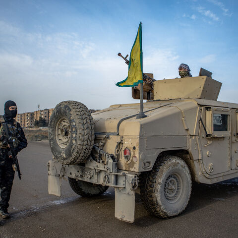 Members of People's Defense Units (YPG) stand guard as Syrian government internal security personnel enter the northeastern city of Hasakeh, a Kurdish stronghold, on Feb. 2, 2026.  
