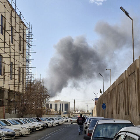 A plume of smoke rises over Tehran after a reported explosion on February 28, 2026, after Israel said it carried out a "preemptive strike" on Iran as sirens sounded in Jerusalem and phone alerts warned of an "extremely serious" threat. (Photo by Ehsan / Middle East Images / AFP via Getty Images)