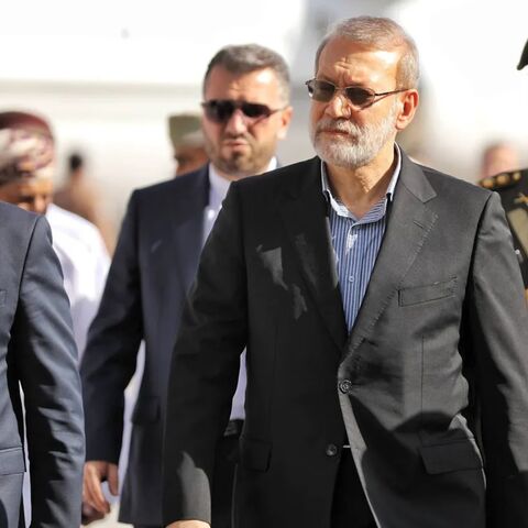 A handout photo made available by Iran's Supreme National Security Council office shows Secretary of the Supreme National Security Council Ali Larijani (C) arriving in Muscat, Oman, on Feb. 10, 2026. 