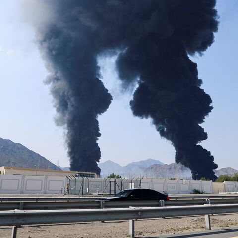 Smoke rises in the Fujairah oil industry zone, caused by debris after interception of a drone by air defenses, according to the Fujairah media office, amid the U.S.-Israel conflict with Iran, in Fujairah, United Arab Emirates, March 14, 2026. REUTERS/Staff