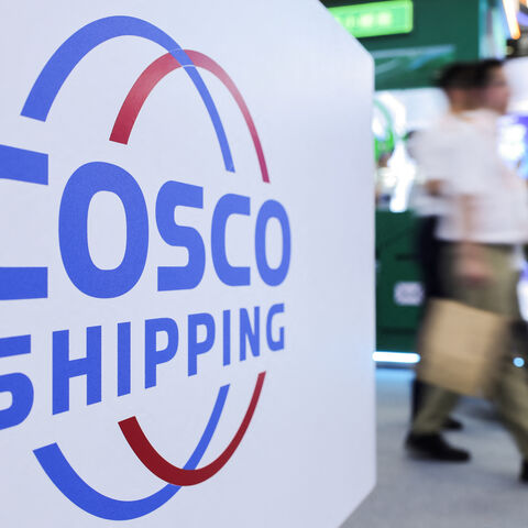 FILE PHOTO: People walk next to a logo of China Ocean Shipping Company (COSCO) at the China International Fair for Trade in Services (CIFTIS) in Beijing, China, September 11, 2025. REUTERS/Maxim Shemetov/File Photo