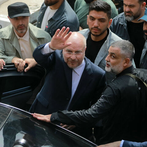 Iran's Parliament Speaker Mohammad Bagher Ghalibaf (C) waves as he returns to his car after visiting the site of an Israeli airstrike that targeted Beirut's Basta neighbourhood, on October 12, 2024. At least 22 people were killed in Israeli strikes on a densely populated area of central Beirut on October 10, the Lebanese health ministry said, with a security source saying a Hezbollah figure was the target. (Photo by Ibrahim AMRO / AFP) (Photo by IBRAHIM AMRO/AFP via Getty Images)