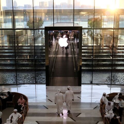 People sit in a cafe outside the Apple Store in Dubai on May 8, 2025.