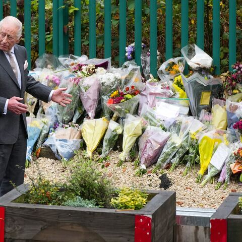 Rabbi Daniel Walker and King Charles III view floral tributes during a visit to Heaton Park Hebrew Congregation Synagogue on Oct. 20, 2025, in Manchester, England. 