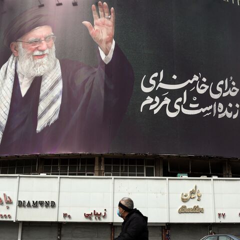 A man rides a motorbike past a billboard of Iran's supreme leader, Ayatollah Ali Khamenei, in Tehran on March 2, 2026. 